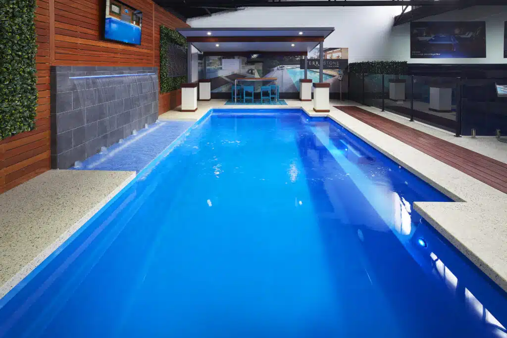 a seamless pool edge pool with waterfall water feature