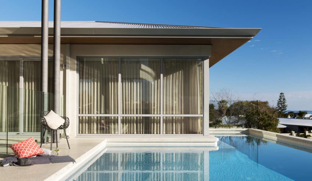 a seamless pool edge with a chair and pillow next to it
