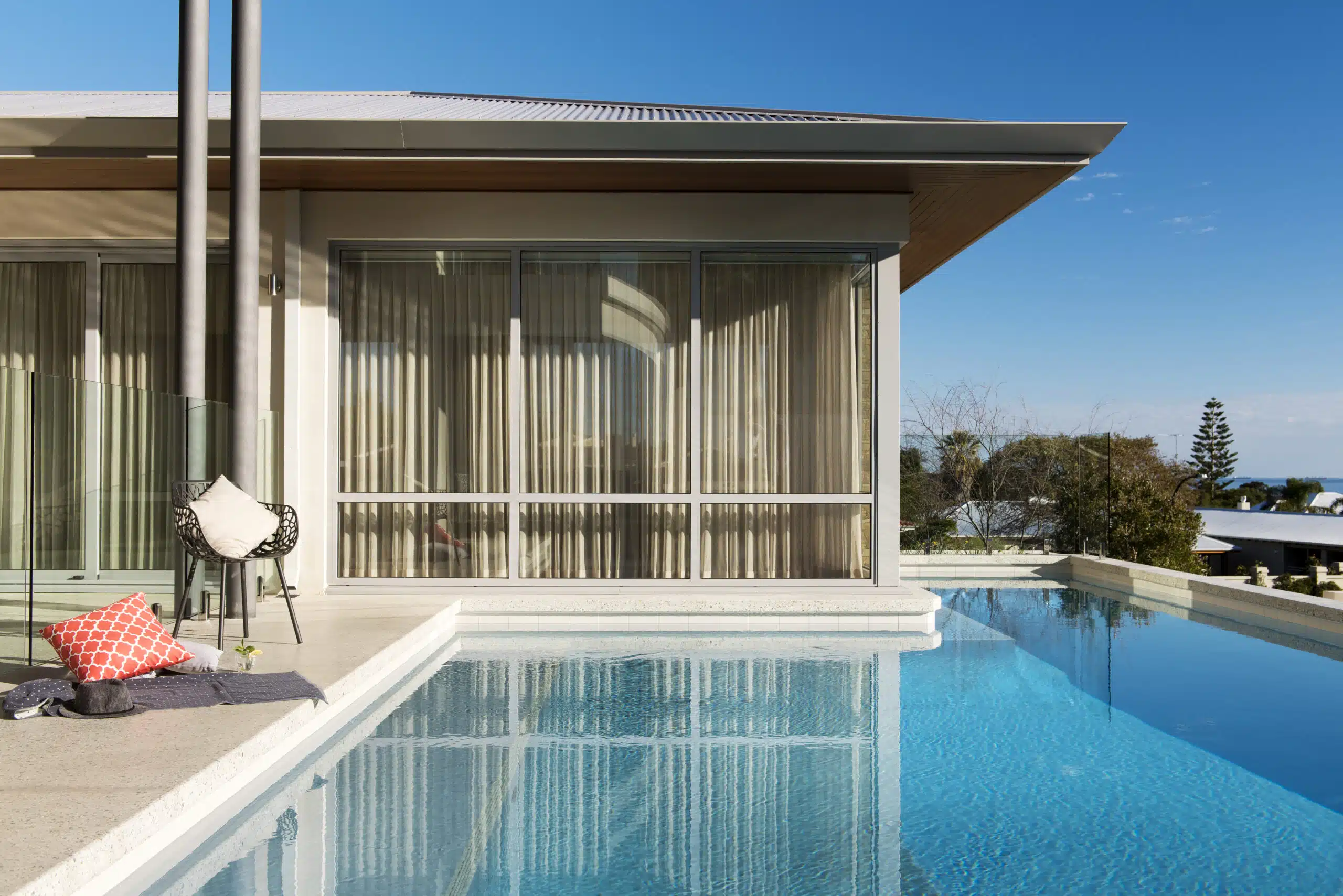 a seamless pool edge with a chair and pillow next to it