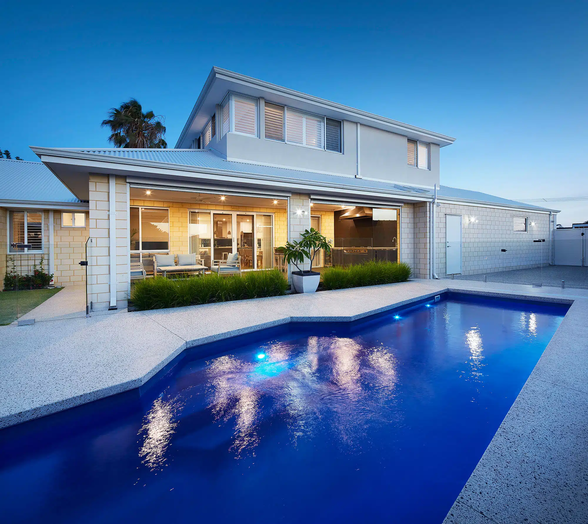 a shot of a swimming pool edged with decorative concrete
