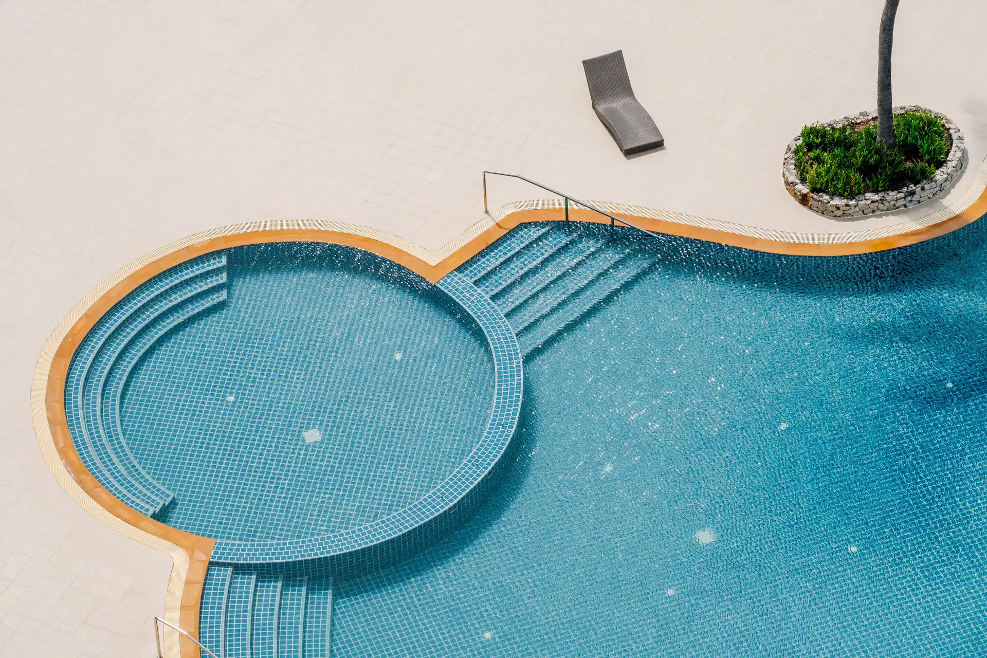 Top down view of a pool surrounded by tiles